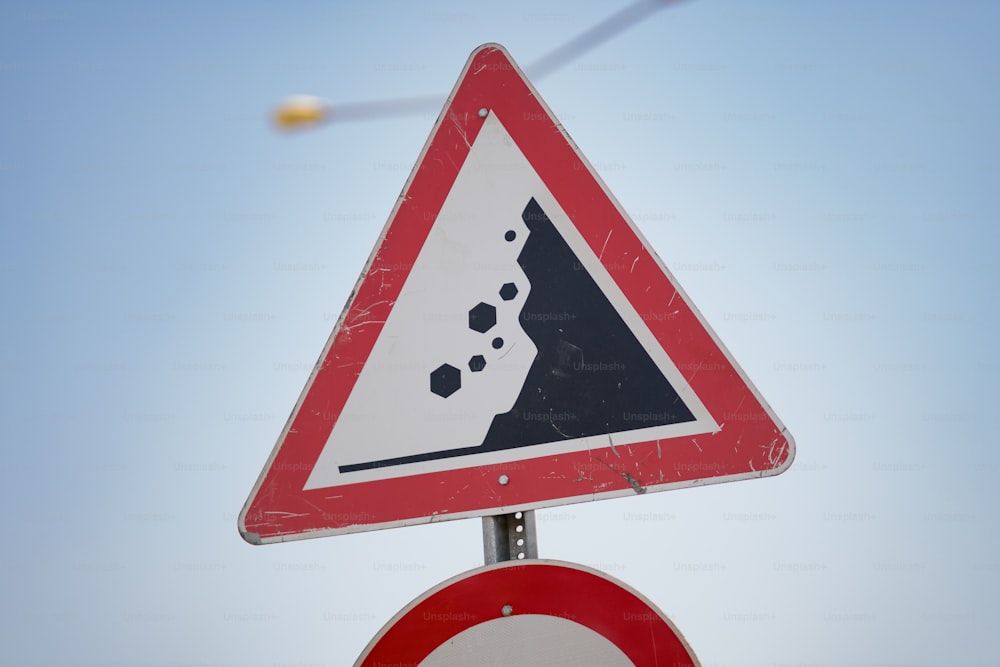 a red white and black sign and some wires