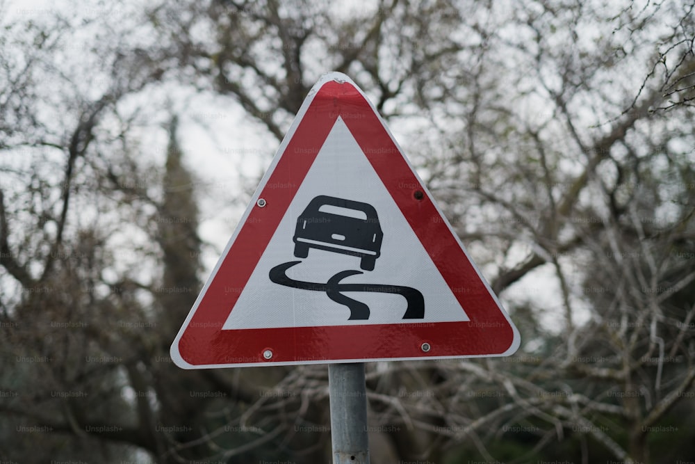 a red and white street sign sitting on top of a metal pole