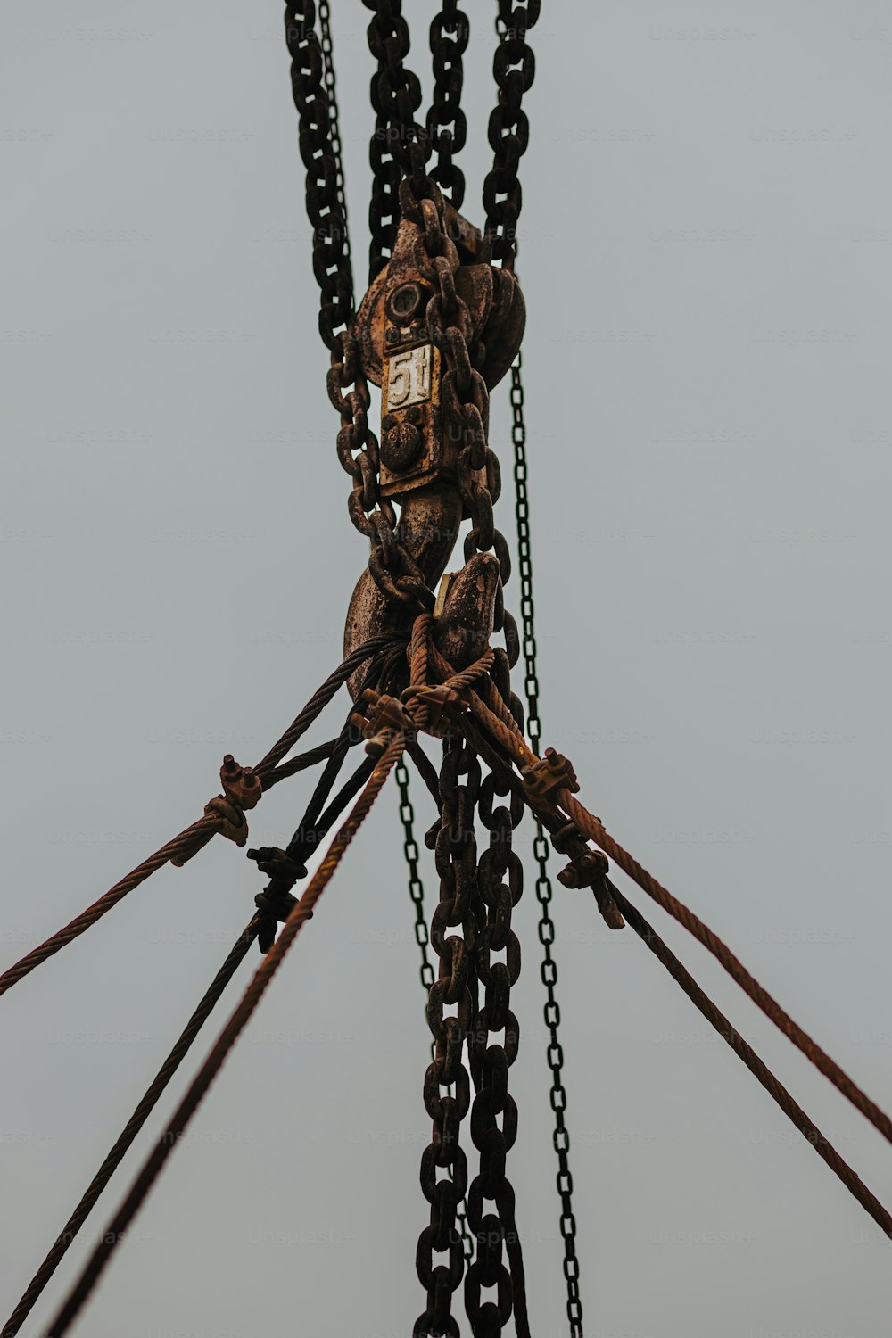 a close up of a chain with a clock on it