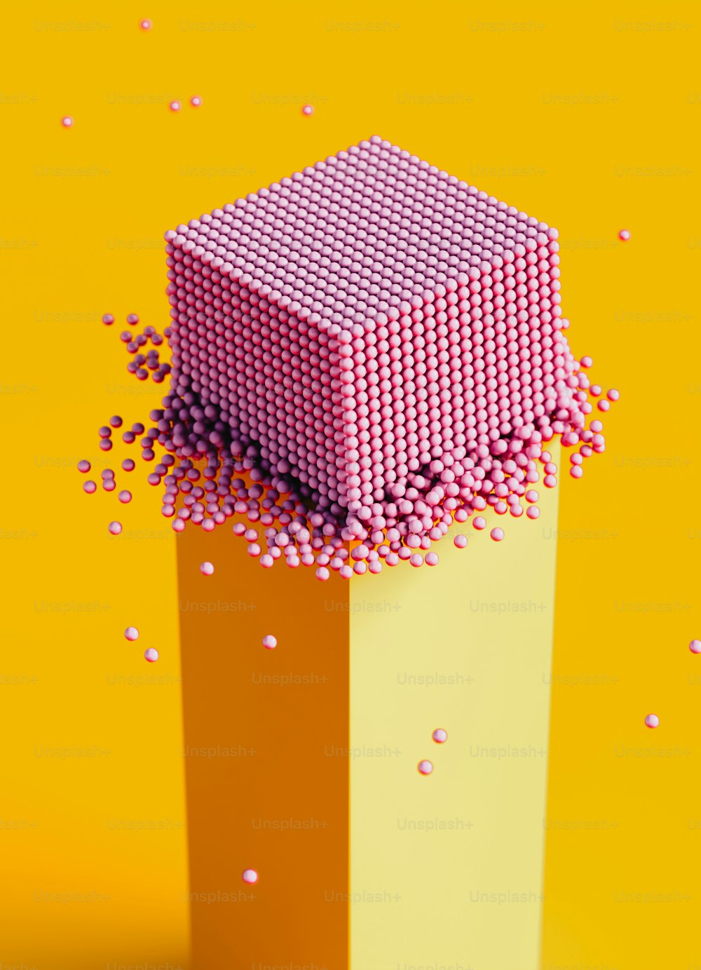 a pink and yellow object with pink dots on it