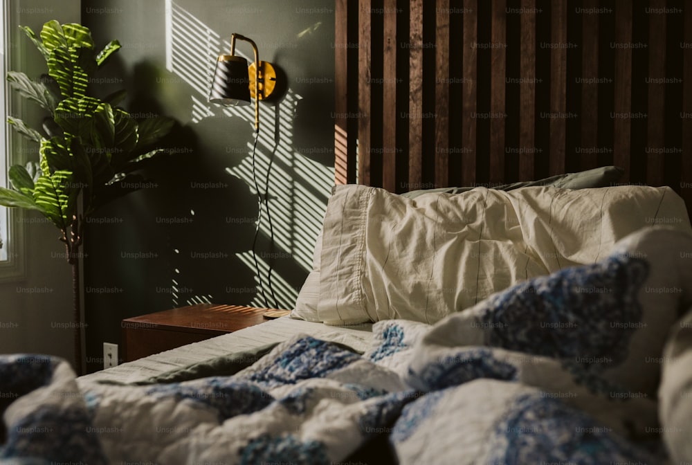 a bed in a bedroom with a wooden head board