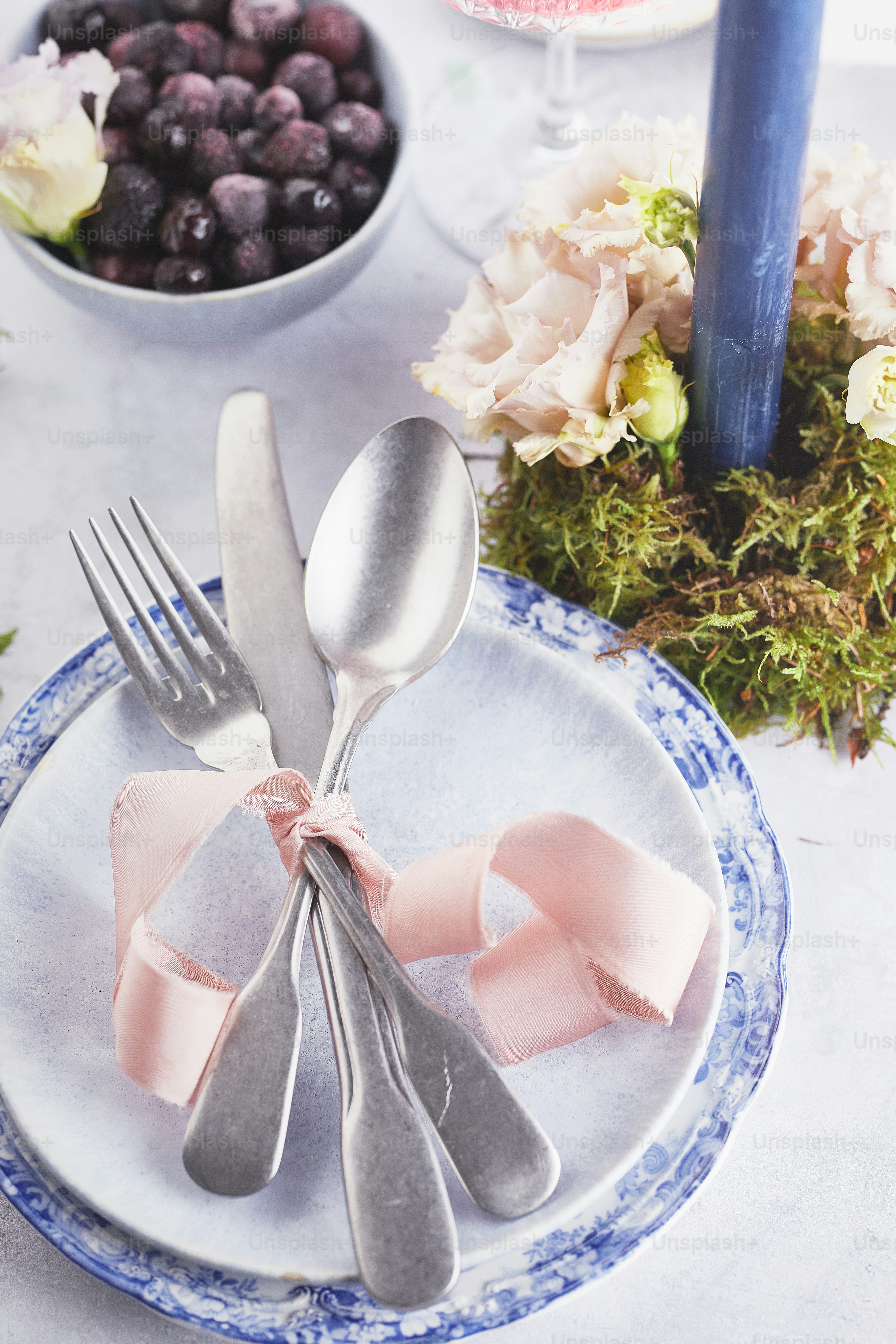a blue and white plate topped with a fork and knife