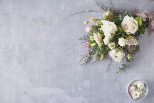 a bouquet of flowers sitting next to a bowl of flowers