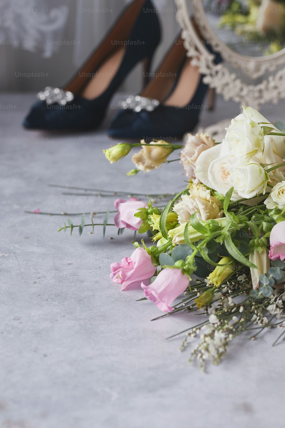 a bouquet of flowers sitting next to a pair of shoes