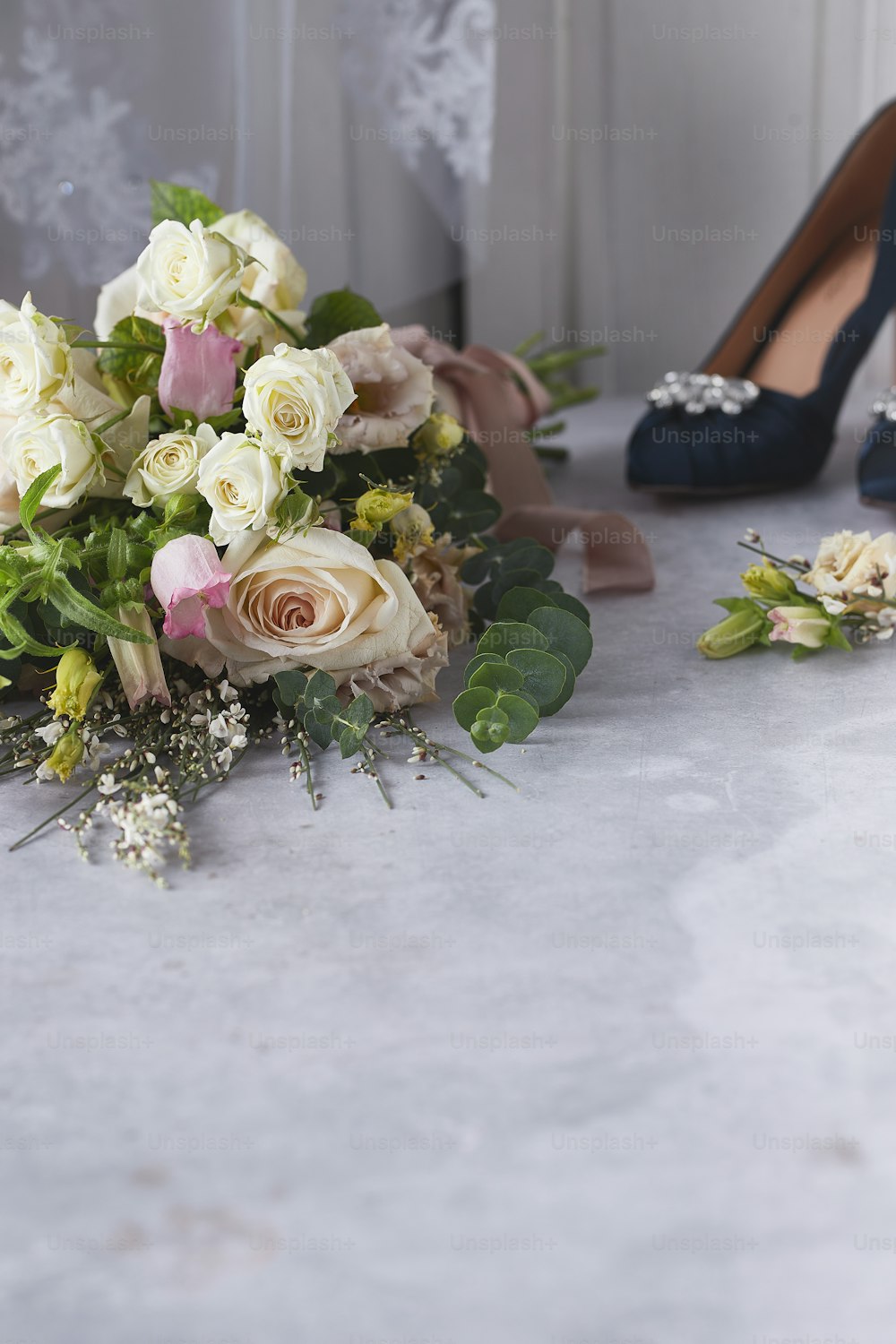 a bridal bouquet and shoes on a table