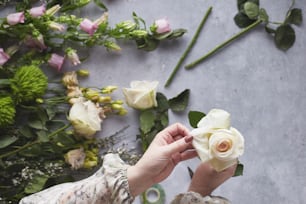 a person holding a flower in front of a bunch of flowers