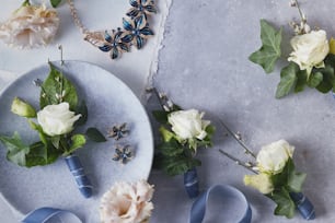 a plate with flowers on it next to a pair of scissors