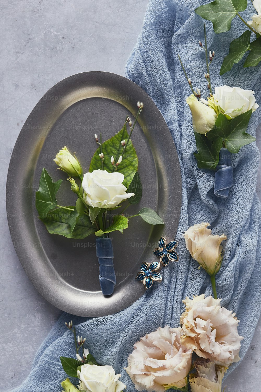 a plate with flowers on it next to a blue towel