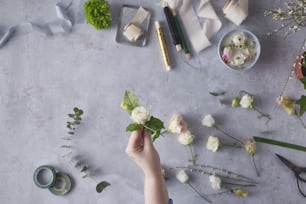 a person arranging flowers on a table