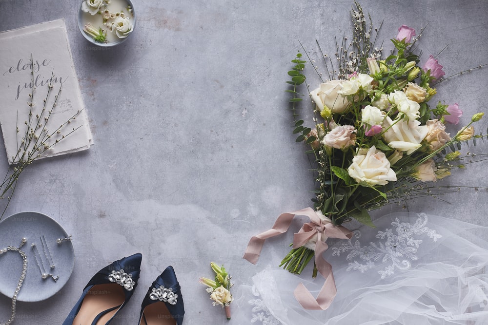 a bouquet of flowers next to a pair of shoes