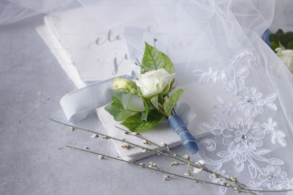 a boutonniere and a bouquet of flowers on a table