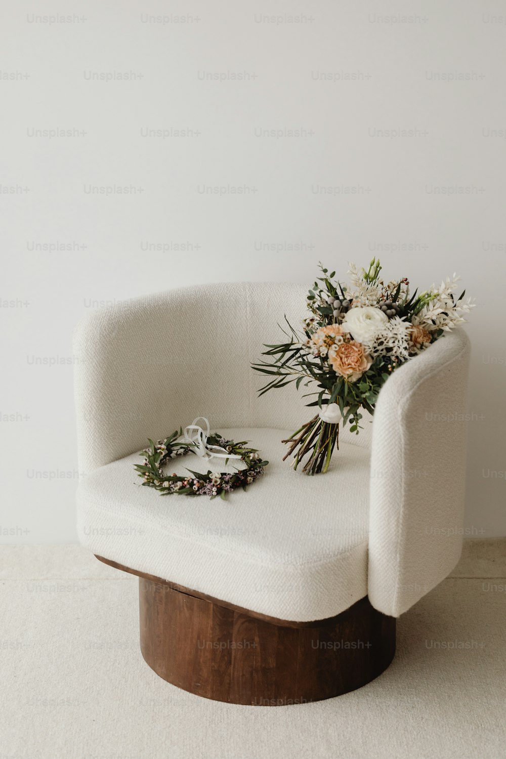 a white chair with a bouquet of flowers on it