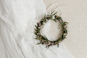 a wreath of flowers is laying on a bed