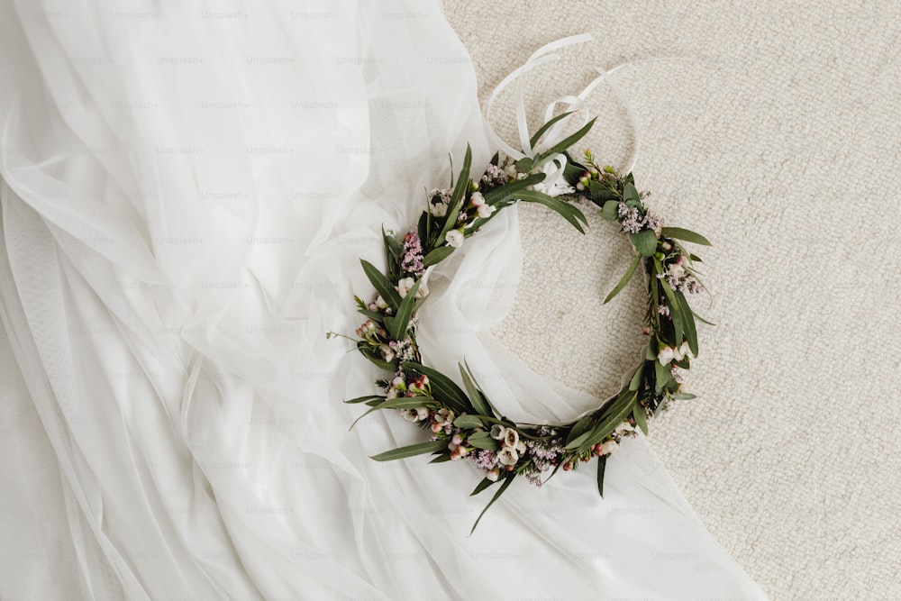 a wreath of flowers is laying on a bed