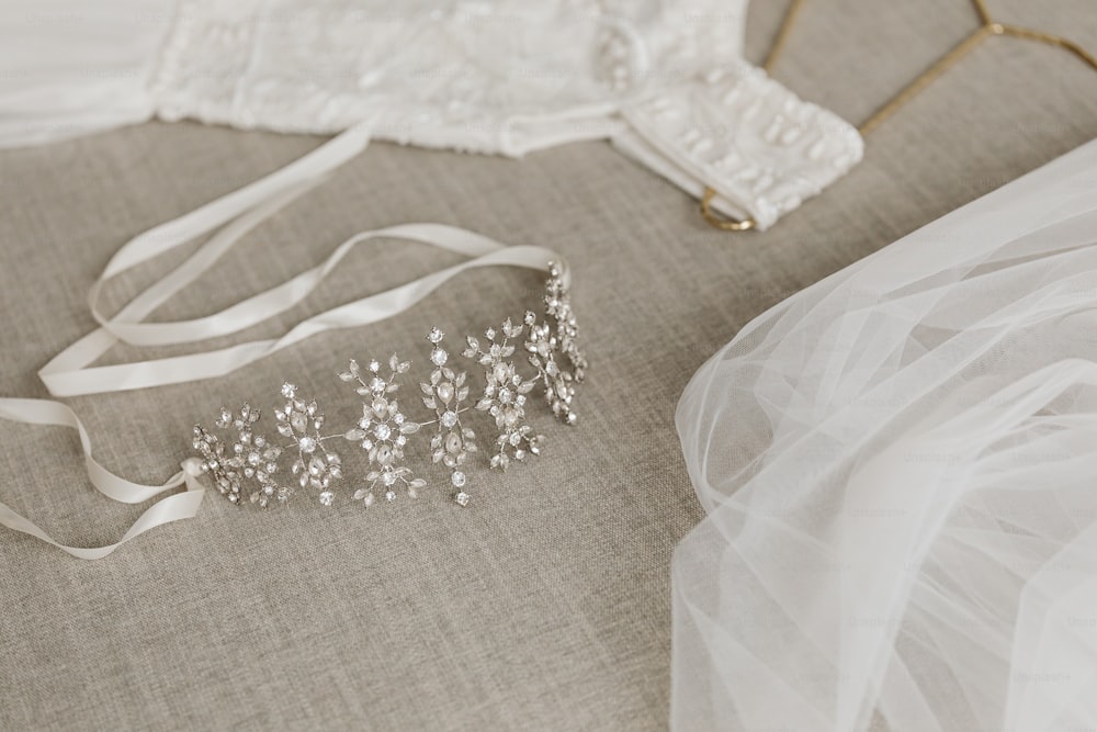 a bridal's tiara and veil on a bed