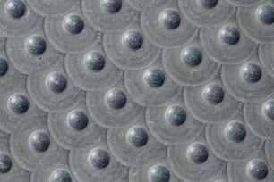 a close up of a metal surface with circles on it