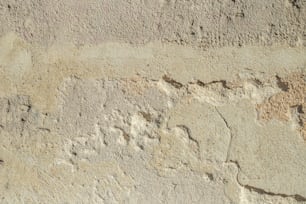 a close up of a cement wall with cracks