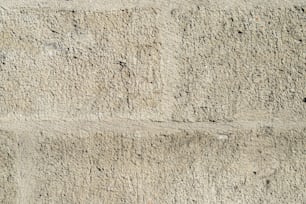a close up of a cement wall with small cracks