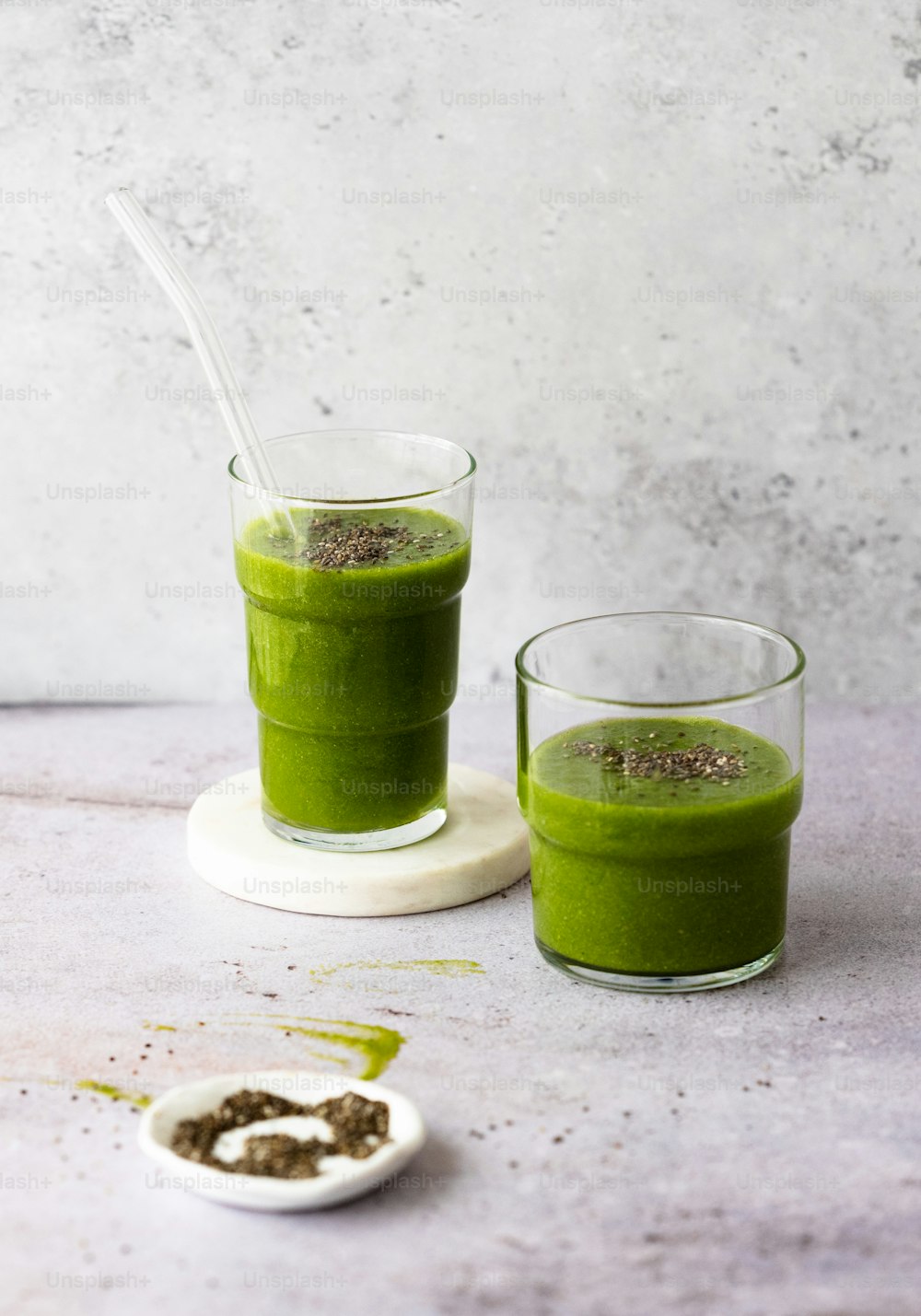 a couple of glasses filled with green smoothie