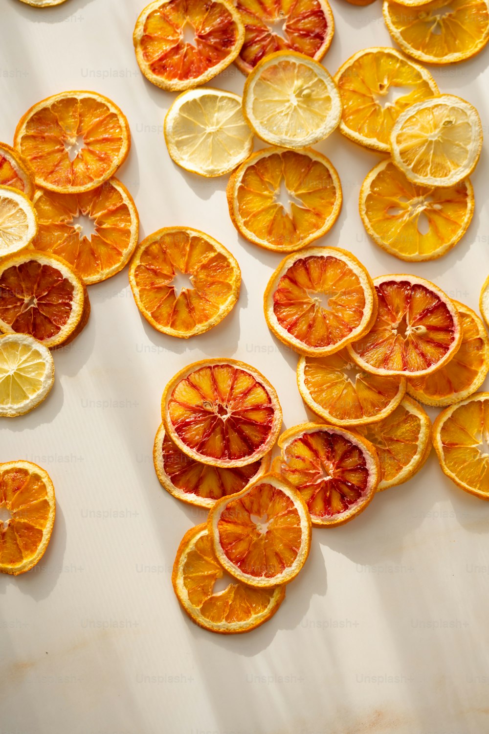 a bunch of oranges cut in half on a table