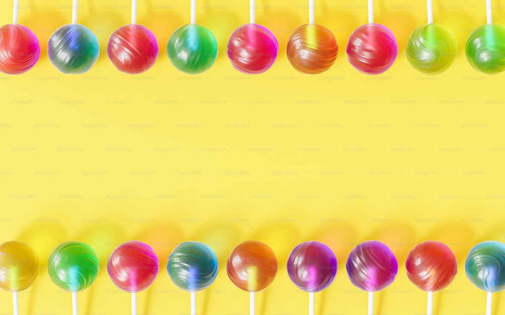 a row of lollipops on a yellow background