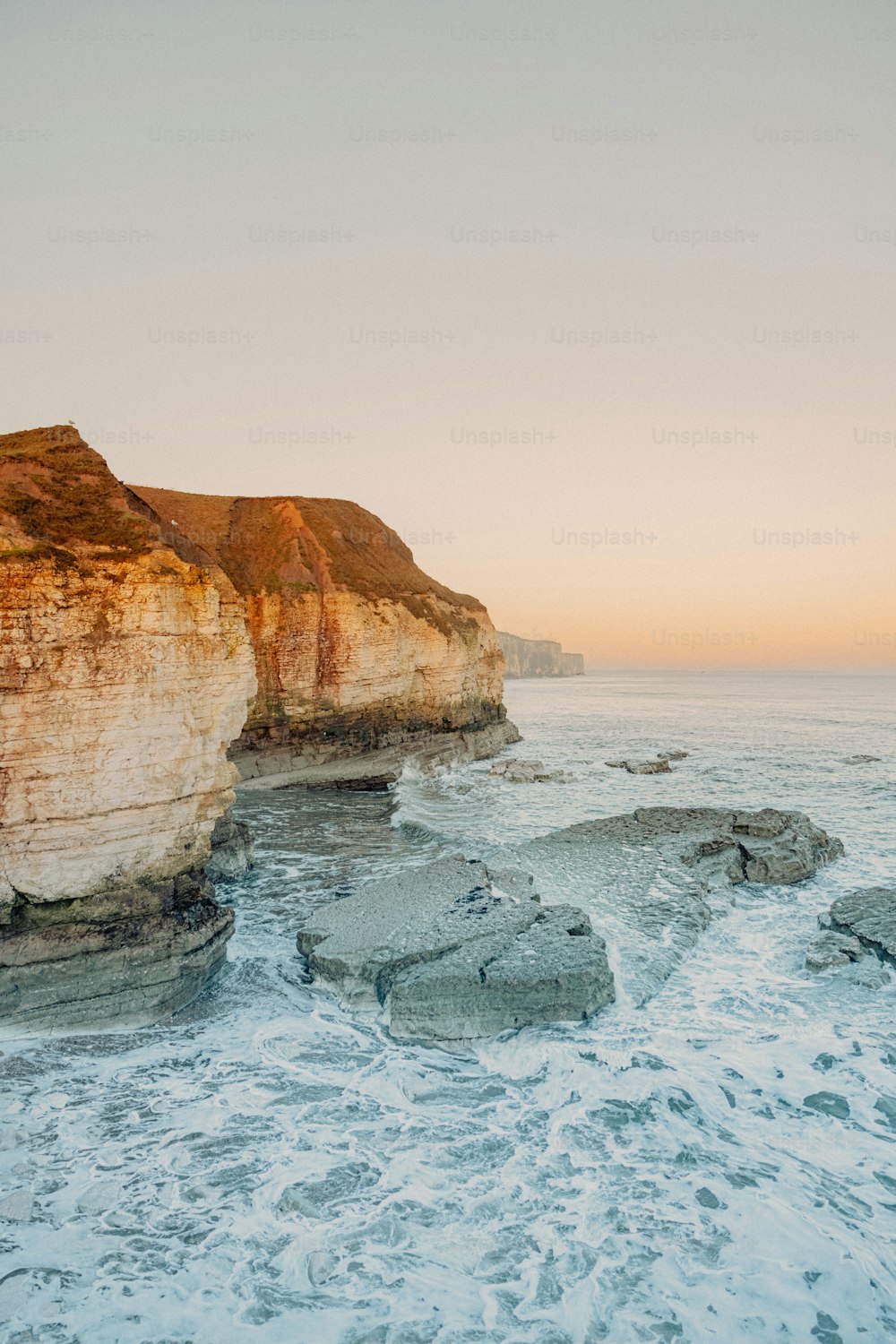 a couple of large rocks sitting on top of a beach