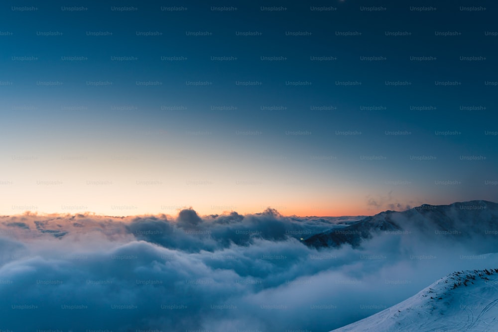 a view of a mountain covered in clouds