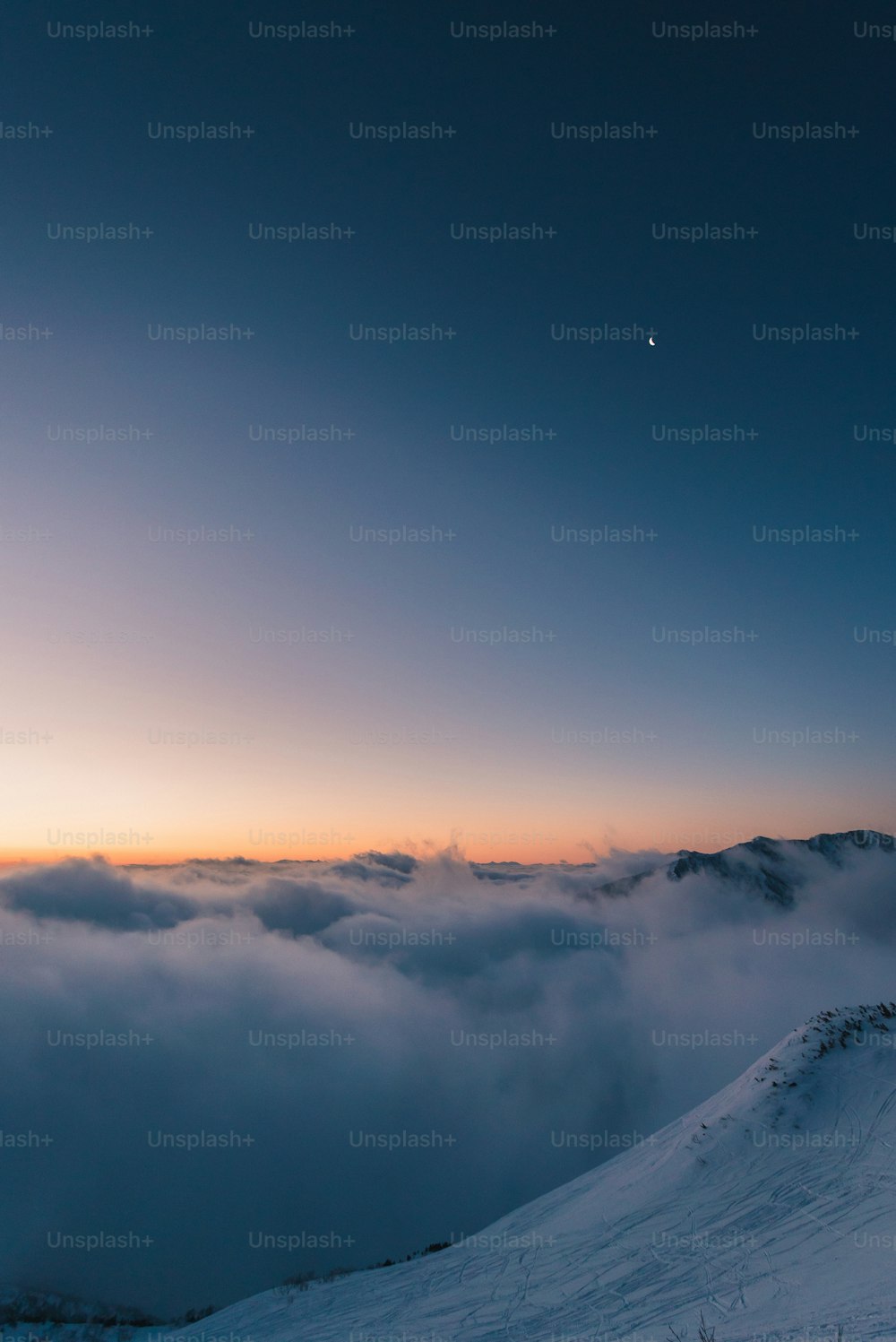 a person standing on top of a snow covered slope