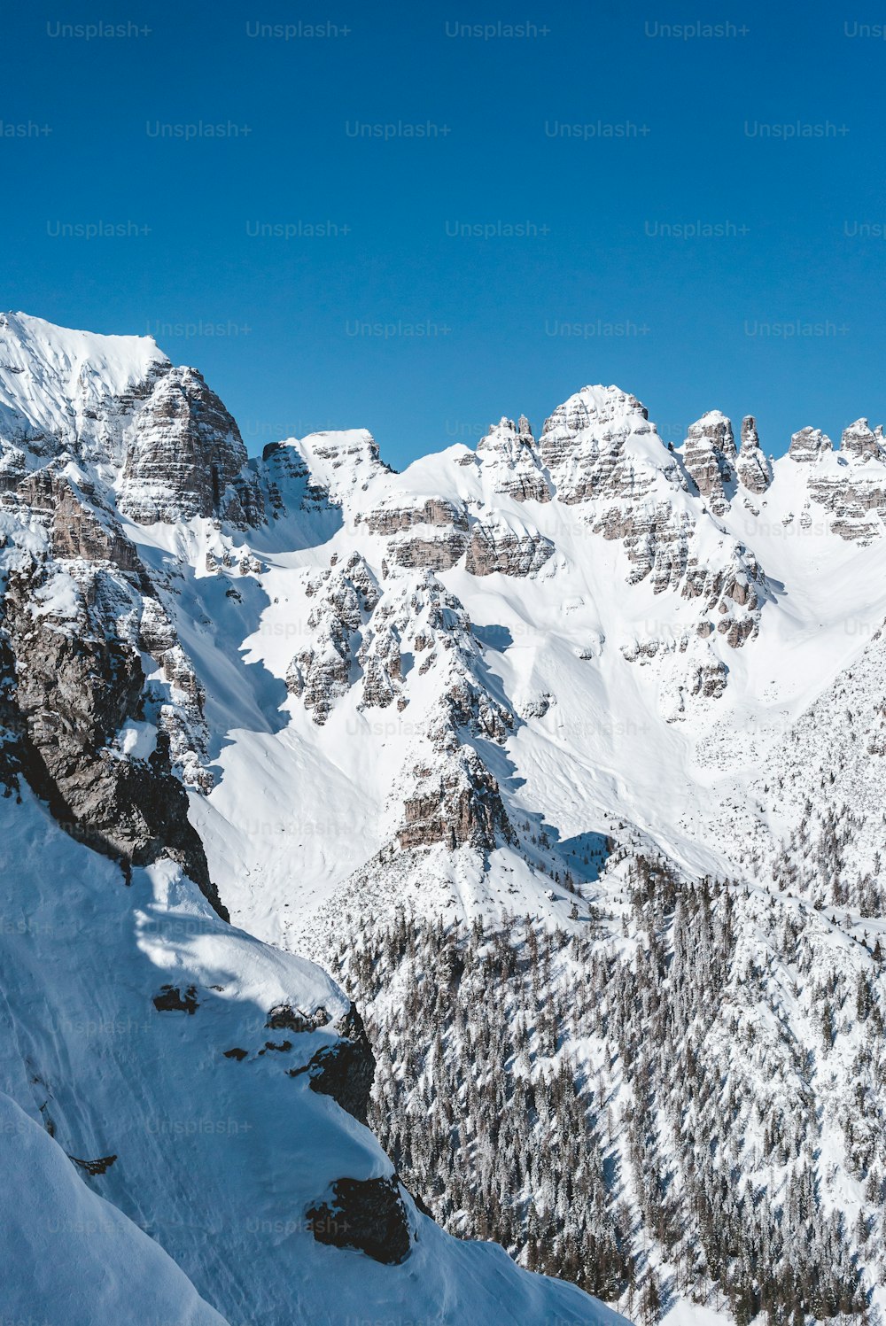 a man riding skis down the side of a snow covered mountain