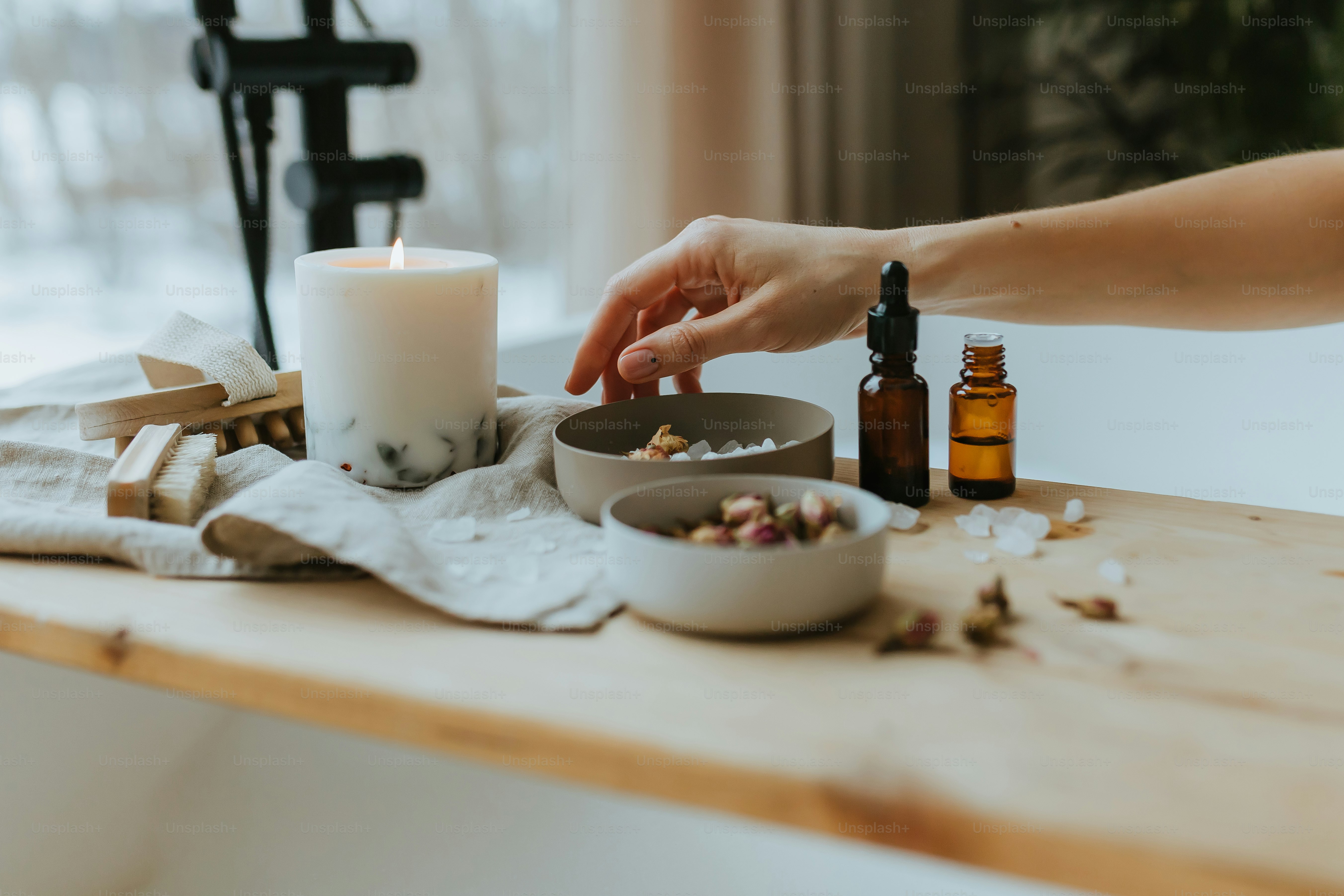 a person lighting a candle on a table