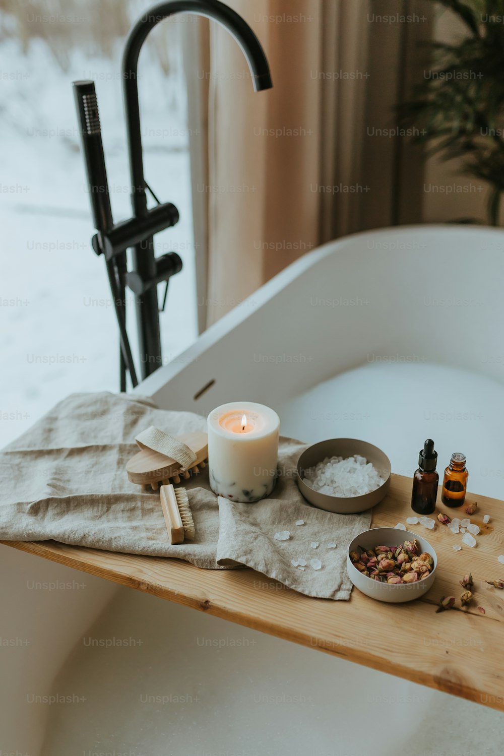 a bathtub with a candle and various ingredients on it