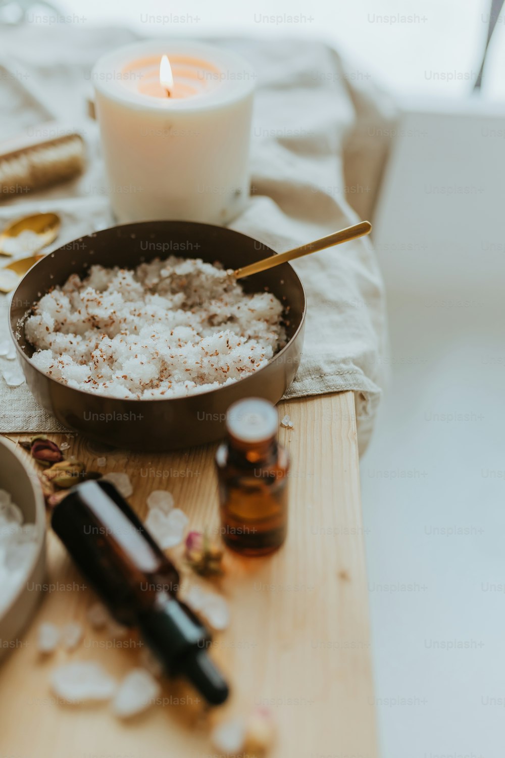 a bowl of oatmeal sitting on a table next to a candle