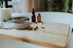 a wooden table topped with a bottle of essential oils