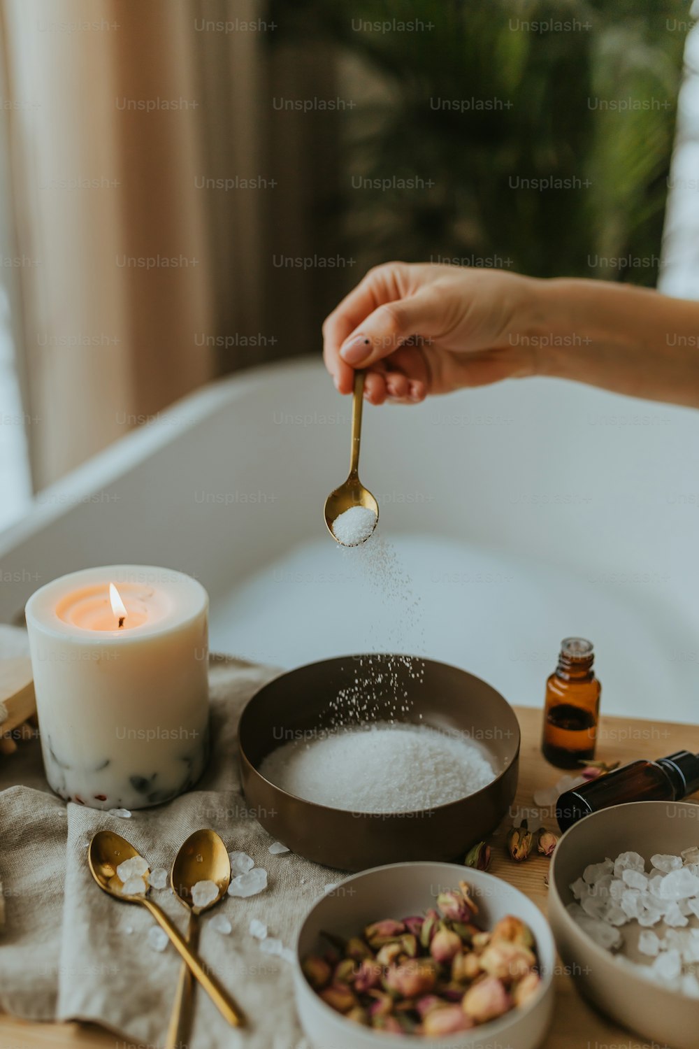 a person is sprinkling sugar into a bowl