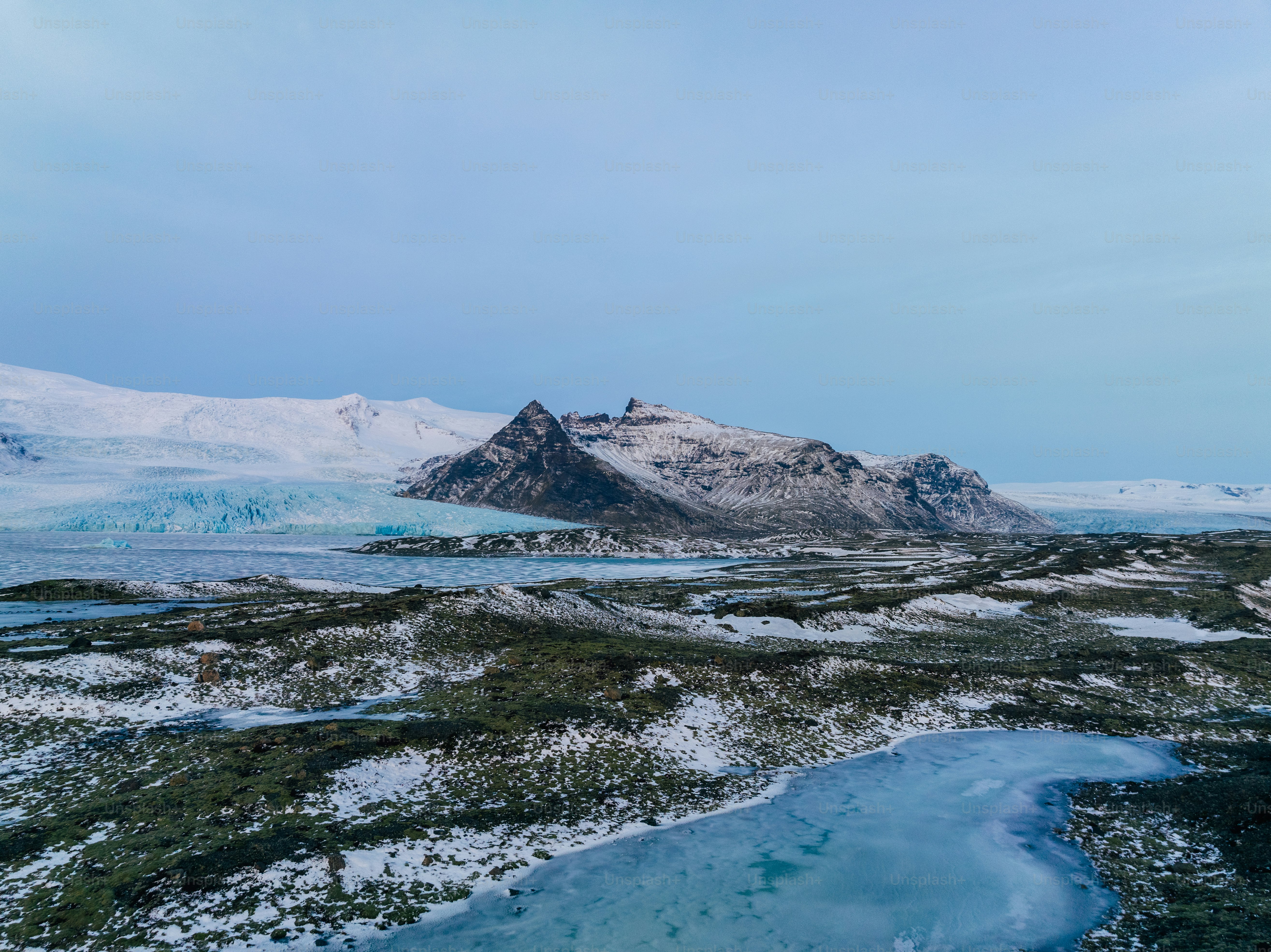 a mountain range with a body of water in the foreground