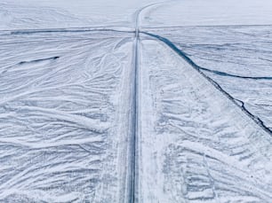 an aerial view of a road in the snow