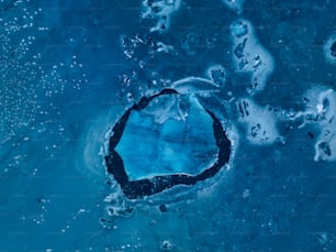 an aerial view of a large blue hole in the water