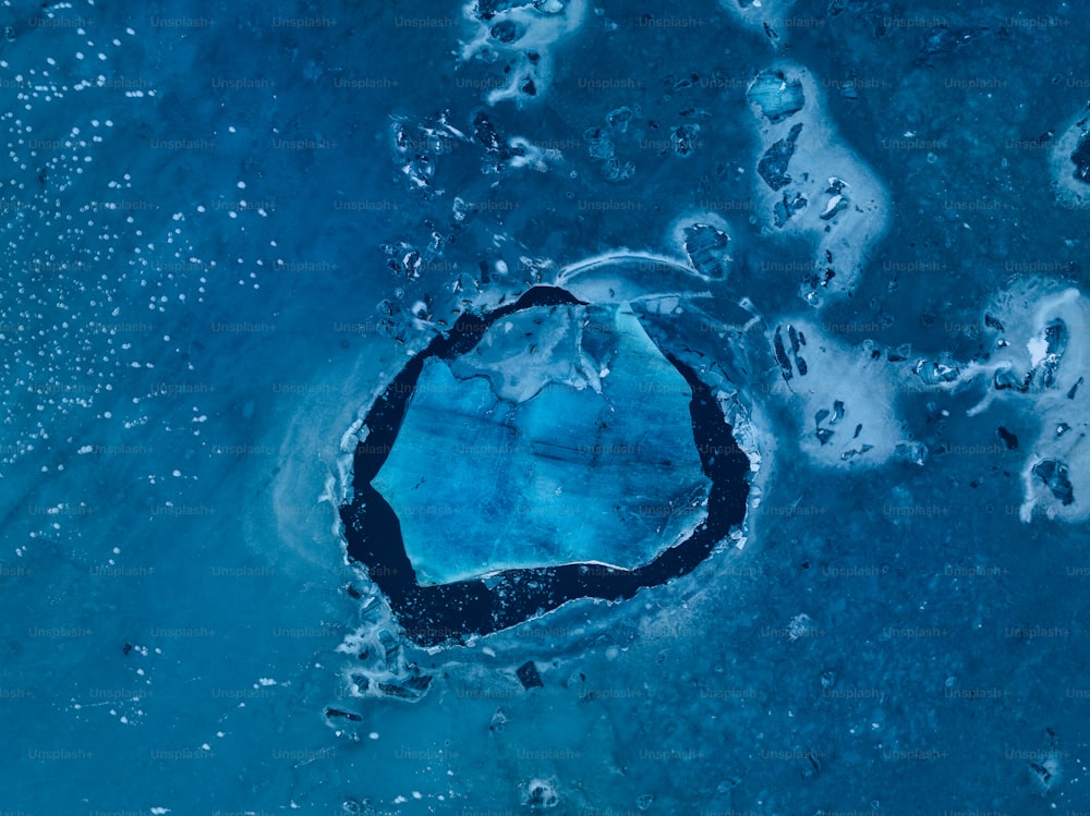 an aerial view of a large blue hole in the water