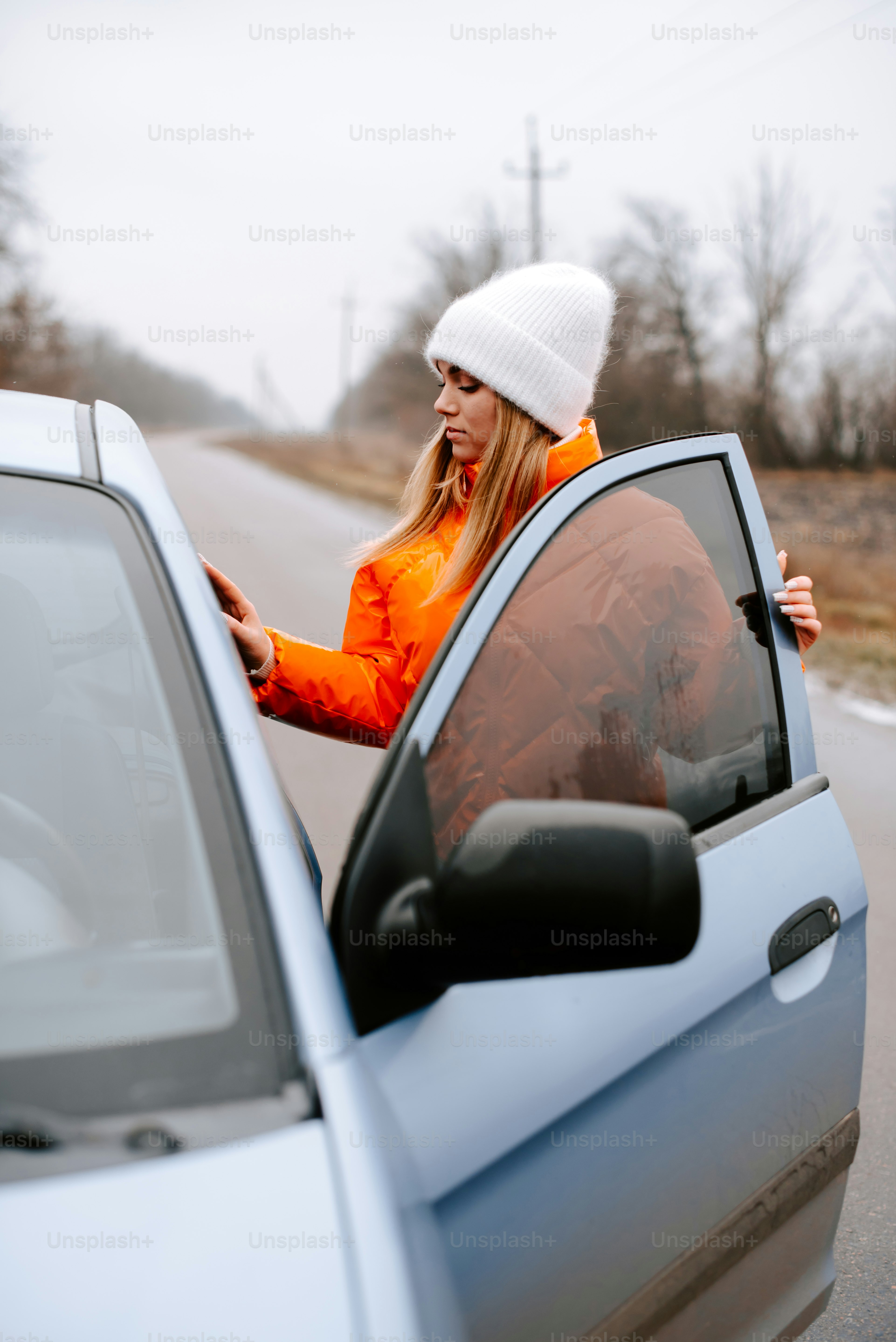 a woman leaning out the window of a car