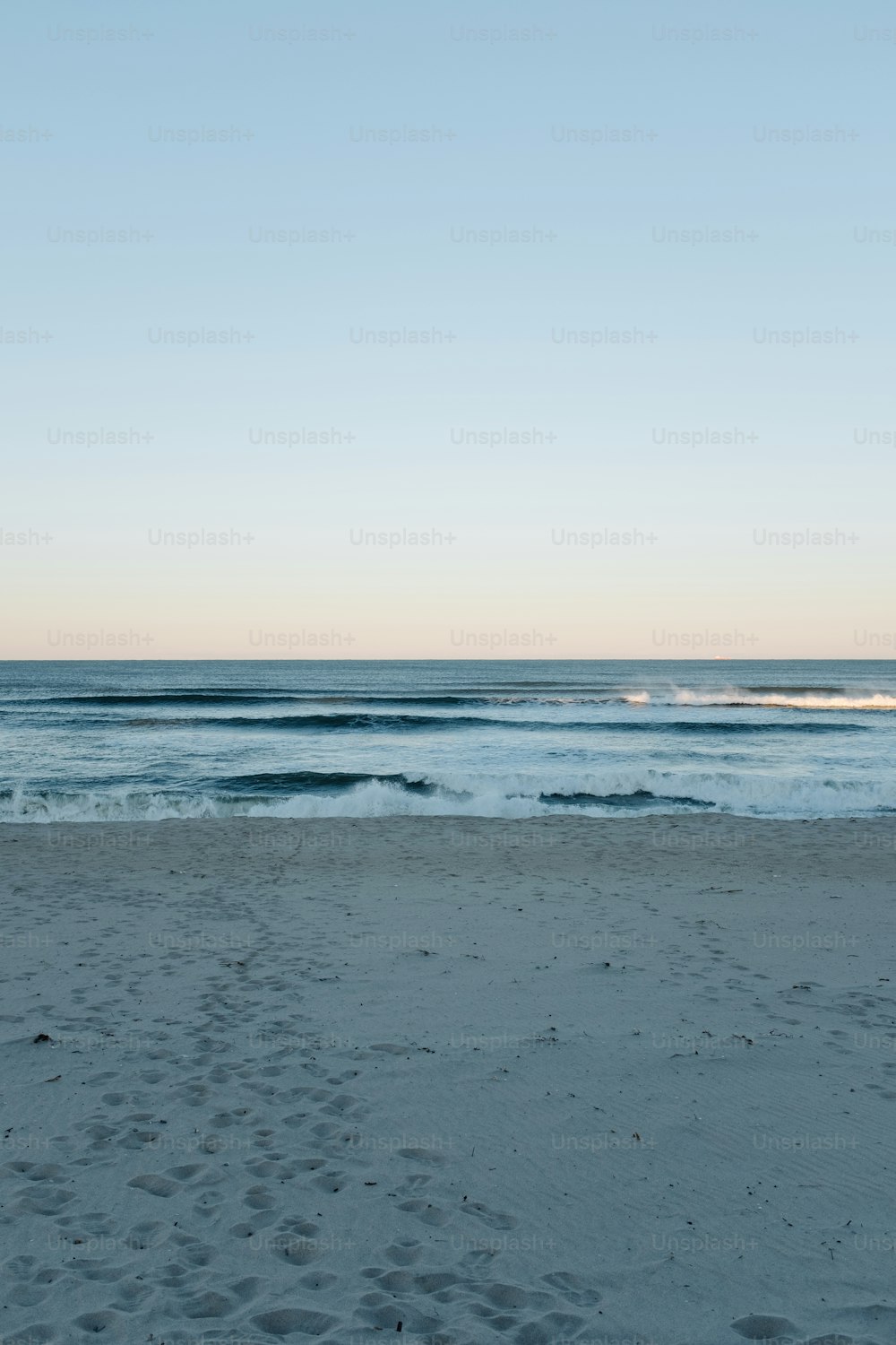 a view of the ocean from a sandy beach