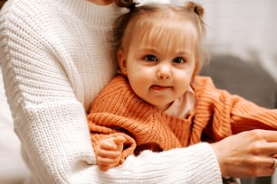 a woman holding a baby in her arms