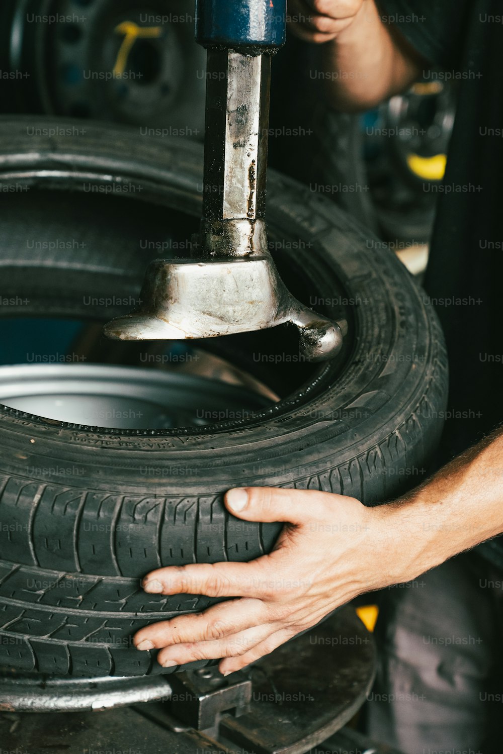 a man working on a tire in a garage