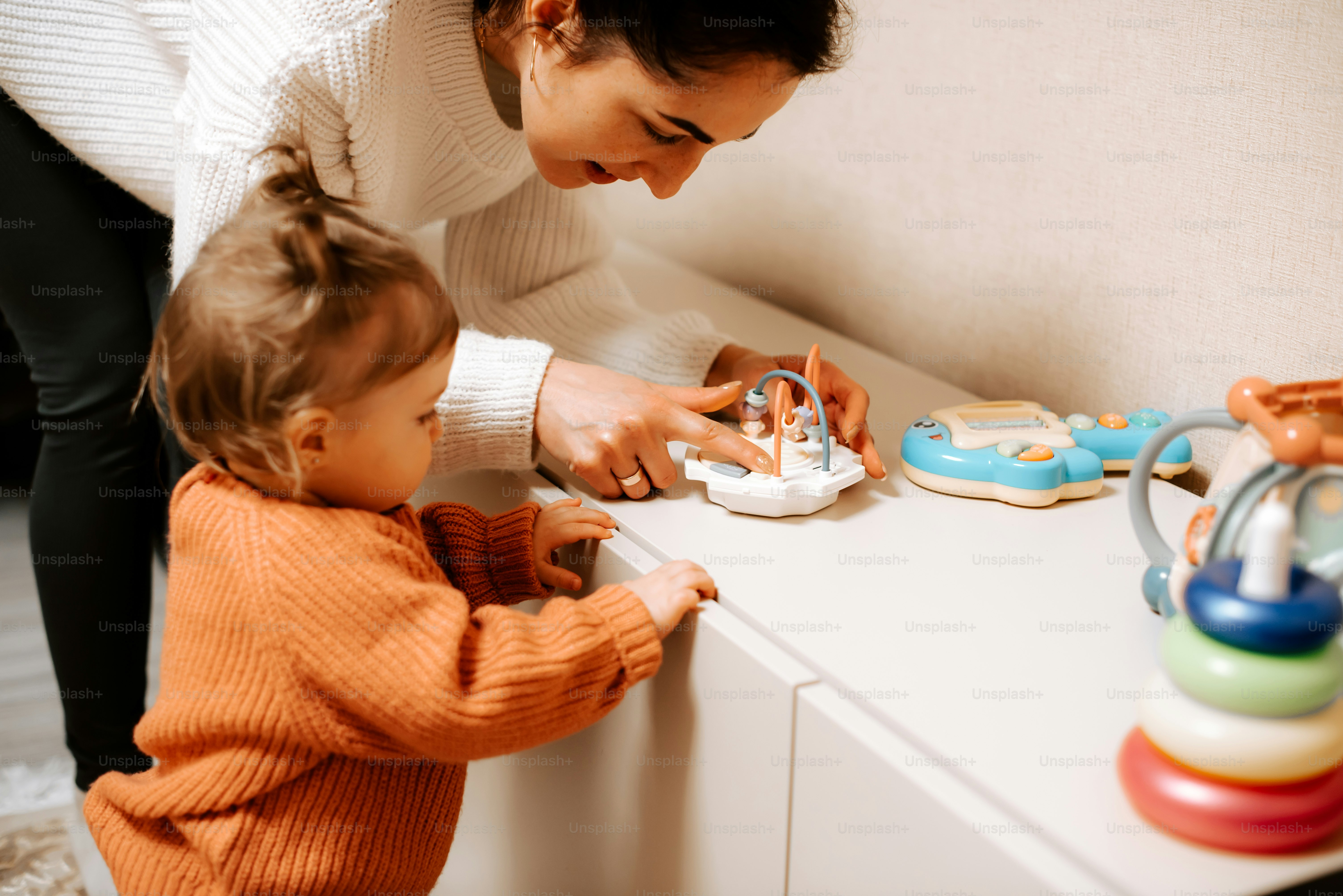 a woman is playing with a small child