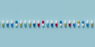 Una fila de píldoras multicolores sobre un fondo azul