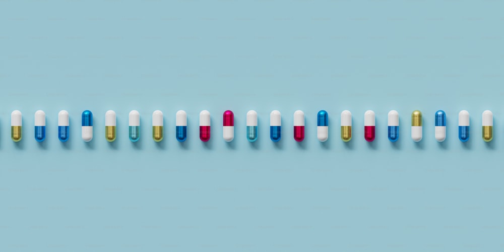 a row of multicolored pills on a blue background