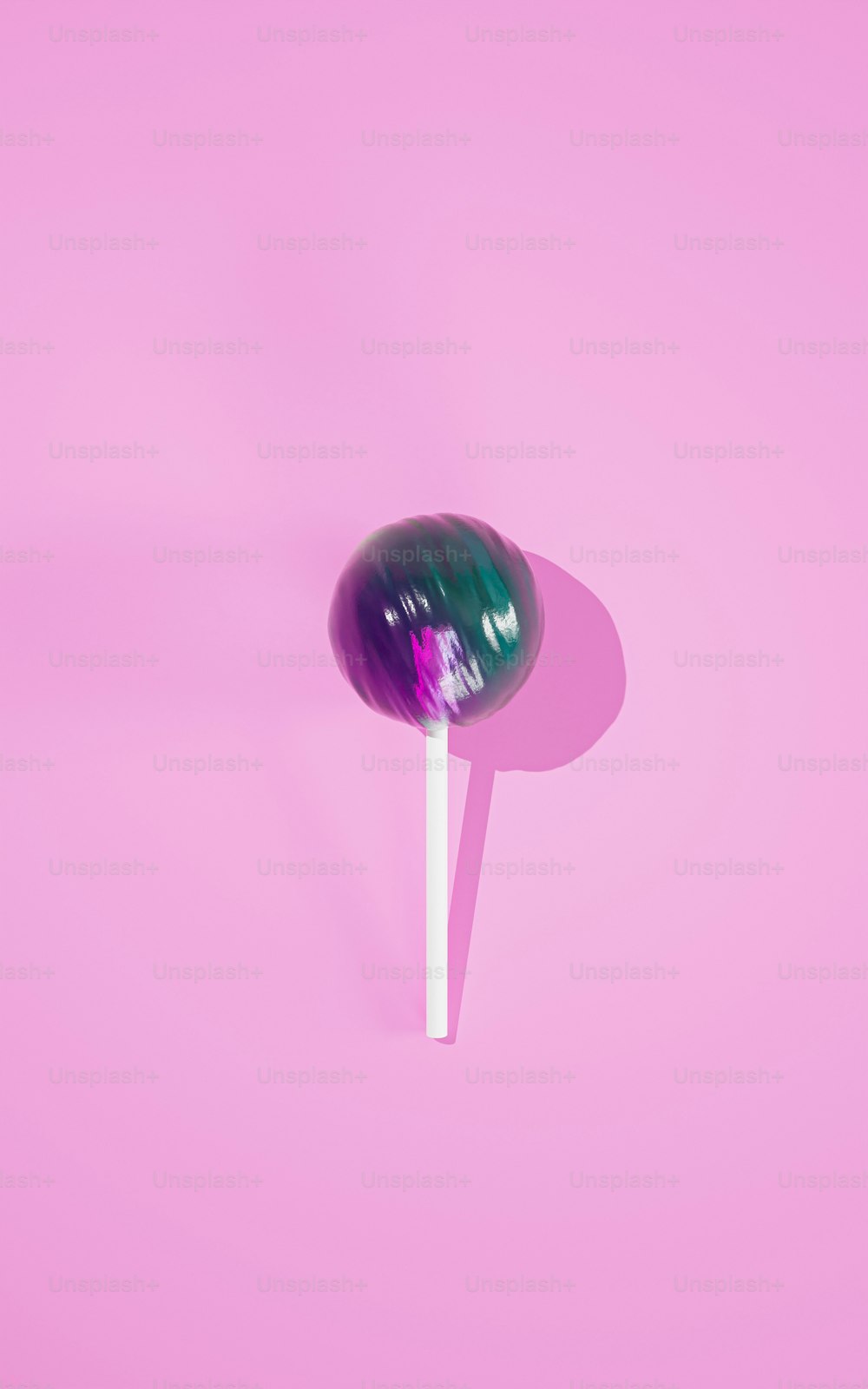a lollipop on a stick on a pink background