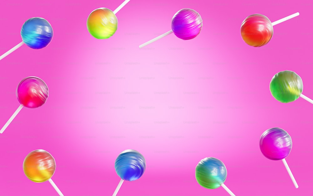 a group of lollipops on a pink background