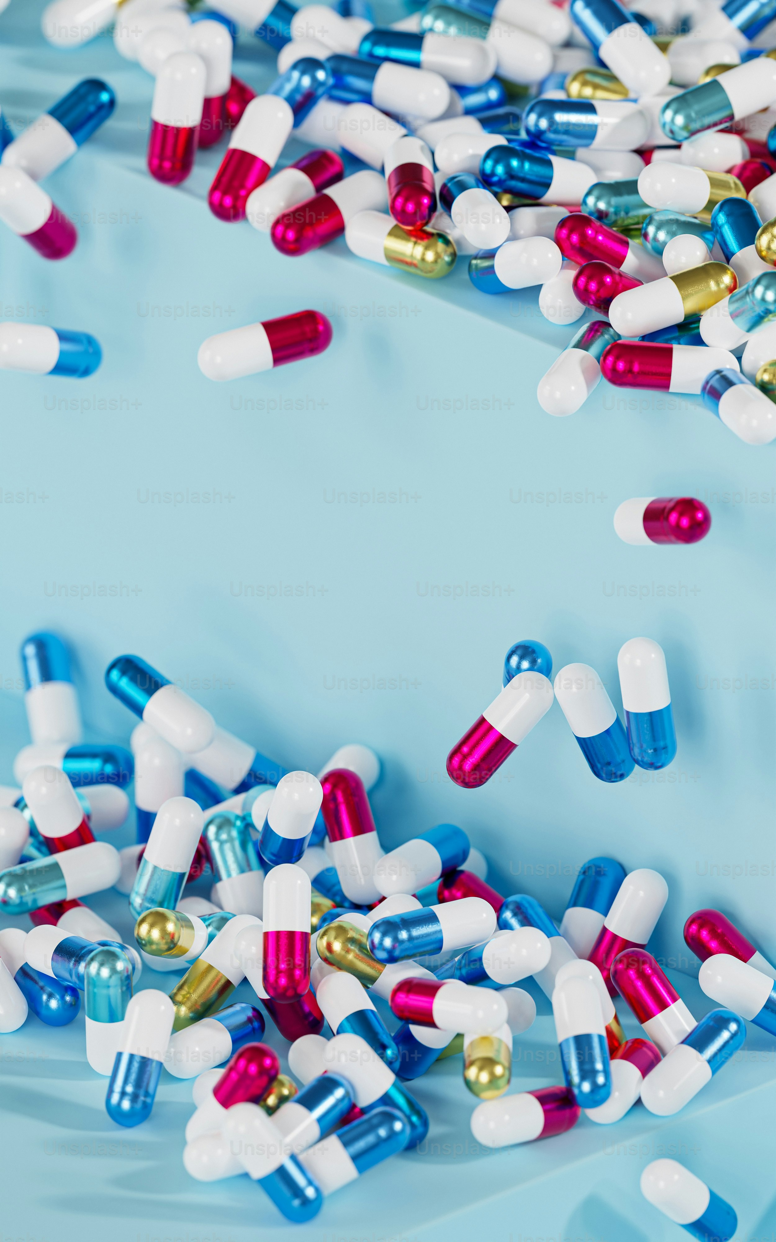 a bunch of pills scattered on top of a blue surface