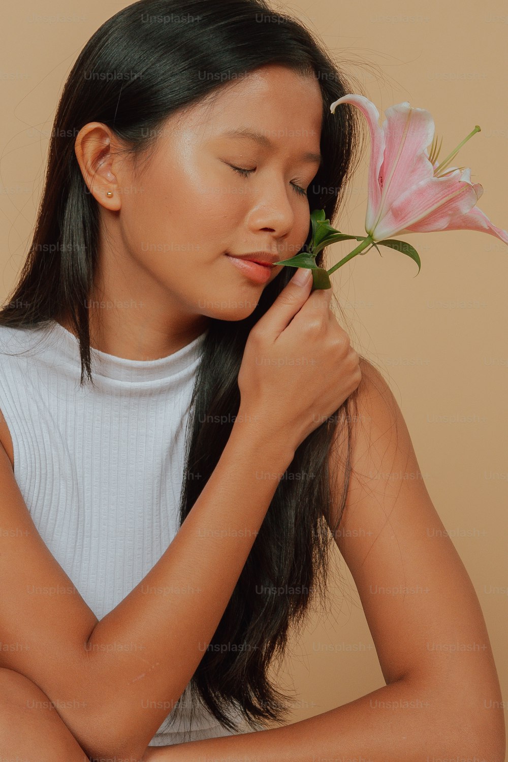 a woman holding a flower in her hands