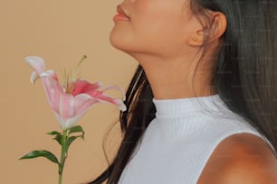 a woman holding a pink flower in her right hand